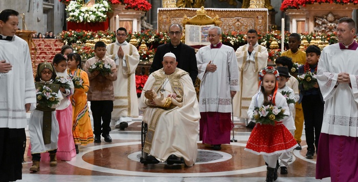  , . (Pope Francis carries the statue of the Child Jesus to place in the Nativity scene inside St. Peter's Basilica at the end of Mass on Christmas Eve, Dec. 24, 2024) 